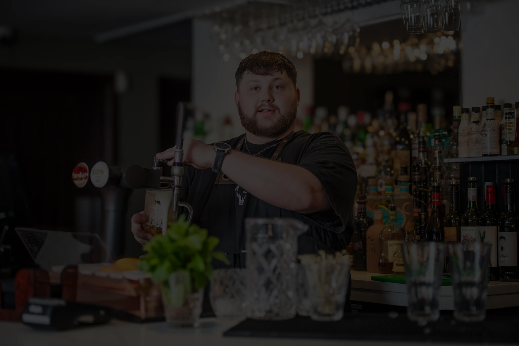 A bartender enjoying a busy day at Oxton Bar